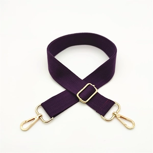 Detail of adjustable deep purple woven shoulder strap with gold metal lobster clasps