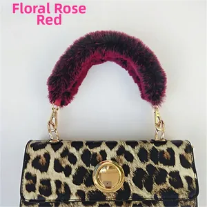 Detail of rose red faux fur handle with leopard print bag and golden metal clasp