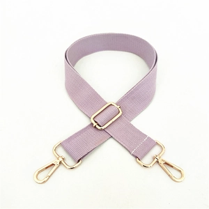 Close-up of lavender wide woven bag strap with adjustable gold hardware and lobster clasps
