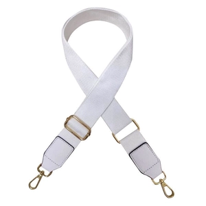 Adjustable white canvas bag strap with leather ends and gold metal buckles shown in detail