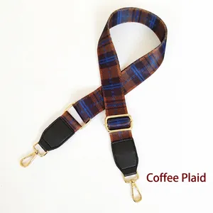 Detail of coffee and blue plaid replacement handbag strap with gold lobster clasps