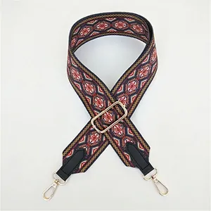 Macro detail of bohemian geometric woven purse strap with gold metal hooks