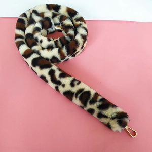 Close-up of leopard print faux fur strap with polished gold-tone metal lobster clasps