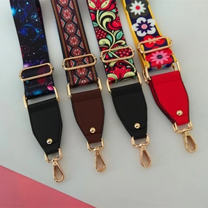 Detail of four ethnic style wide shoulder straps for bags with golden metal hooks