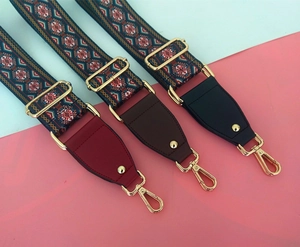 Close-up of three colorful ethnic style woven bag straps with gold hardware and leather details