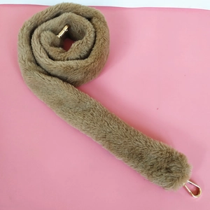 Detail view of soft brown faux fur replacement shoulder strap with gold metal lobster clasps
