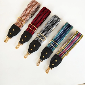 Ethnic style wide embroidered bag straps with gold metal hardware and leather ends