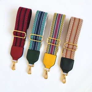 Detail of four colorful woven wide shoulder straps with gold lobster clasps and leather ends