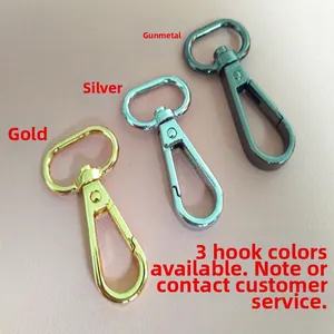 Close-up of metal swivel snap hooks in gold, silver, and gunmetal for bag straps