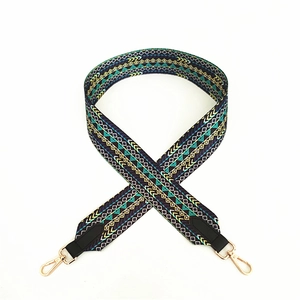 Close-up of wide bohemian geometric woven bag strap with golden swivel snap hooks