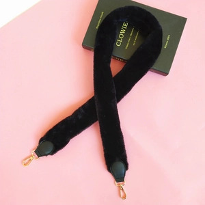 Detail showing the black faux rabbit fur shoulder strap with golden metal swivel hooks