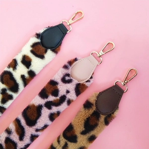 Close-up of leopard print faux fur bag straps with gold metal lobster clasps and PU ends