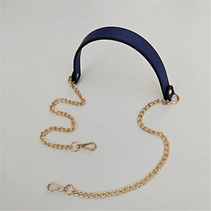 Detail of navy blue PU leather strap with golden metal chains and lobster clasps