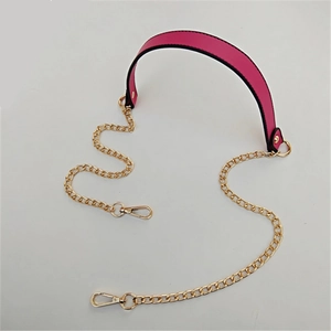 Detail of rose red PU leather strap with gold metal chain and lobster clasps for bags