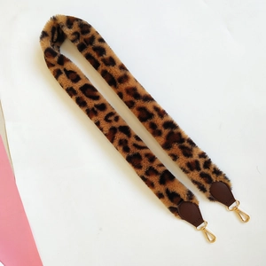 Close-up of leopard print faux fur bag strap featuring durable gold lobster clasps