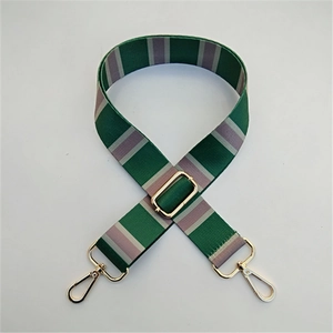 Detail of adjustable woven wide shoulder strap with green and lavender stripes and gold clips