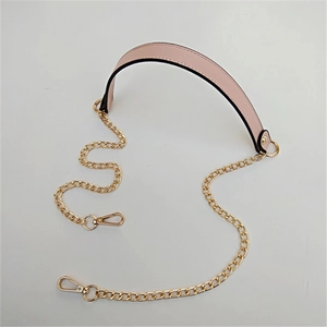 Detail of pink PU leather shoulder strap pad with golden metal chain links and lobster clasps