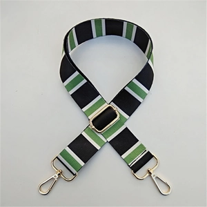 Detail of adjustable wide canvas shoulder strap with black, green, and white stripes