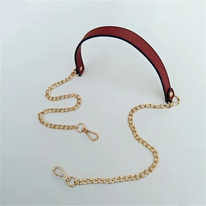 Detail view of burgundy PU leather handle with gold metal chains and lobster clasps
