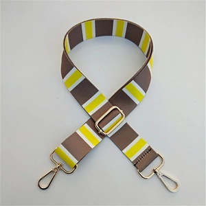 Close-up of adjustable striped replacement strap with light gold metal lobster clasps