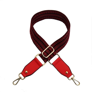 Adjustable crossbody bag strap with red and black geometric embroidery and gold hardware