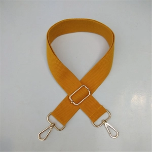 Detailed view of yellow canvas strap with polished gold-tone metal buckles and hooks