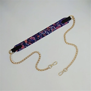 Detail of paisley print fabric strap with golden metal chains and lobster clasps for bags