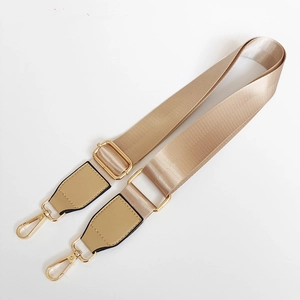 Adjustable champagne gold nylon shoulder strap with leather ends and golden metal clips