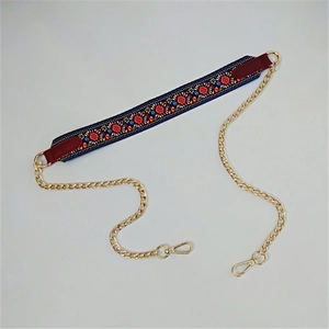 Detail of bohemian floral embroidery strap with gold chain for women handbags