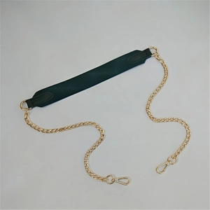 Detail of green canvas shoulder pad with gold metal chain for handbag accessories