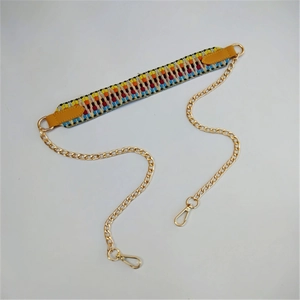 Ethnic woven bag strap with golden metal chains and yellow leather detailing