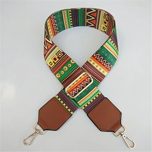 Close-up of ethnic geometric woven strap with leather ends and gold lobster clasps