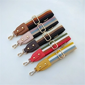 Detail of five colorful striped adjustable straps with gold hardware and PU ends