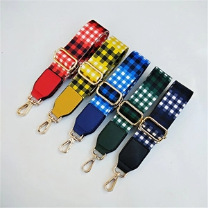 Detail view of five checkered wide shoulder straps with golden metal lobster clasps