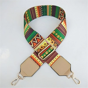 Macro shot of ethnic geometric pattern wide strap with leather ends and gold metal buckle