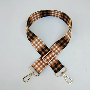 Detailed close-up of adjustable woven canvas strap with classic plaid pattern and gold buckle