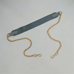 Close-up of gray fabric and gold chain shoulder strap with metal lobster clasps