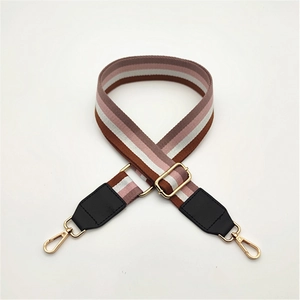 Adjustable striped fabric bag strap with black leather ends and gold metal hooks