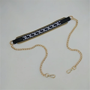 Detail of b&w geometric interlocking pattern strap with gold chain and lobster clasps
