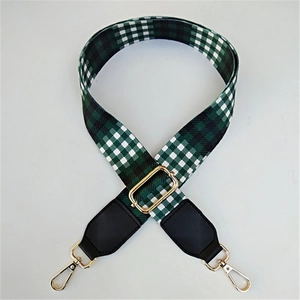 Detail of adjustable green and white gingham wide strap with golden metal lobster clasps