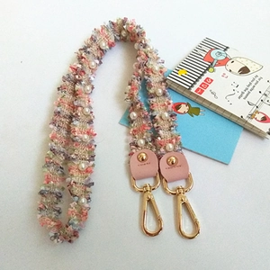 Elegant tweed and pearl purse strap with pink leather ends and golden metal clasps