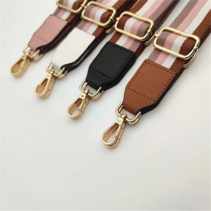 Detail showing various colorful ethnic woven bag straps with gold metal clasps and PU leather ends