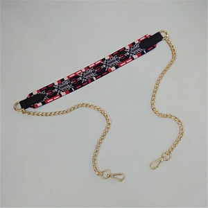 Detail of red and black geometric printed strap with gold metal chain and lobster clasps