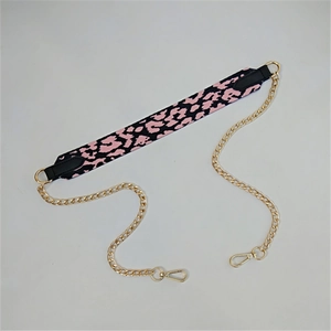 Detail view of pink leopard print fabric strap with gold metal chain and lobster clasps