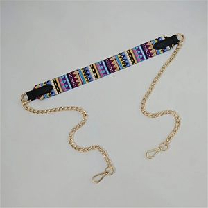 Detail view of colorful geometric ethnic strap with golden metal link chain and lobster clasps