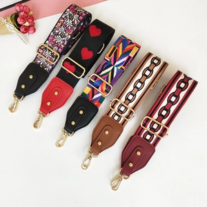 Adjustable wide replacement bag straps in floral and geometric patterns with gold hooks
