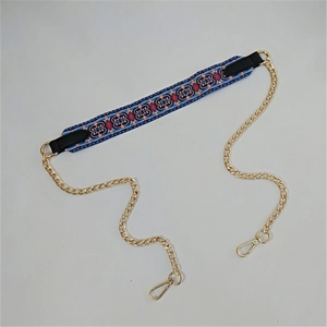 Detail of colorful ethnic pattern shoulder strap with golden metal chains and clasps