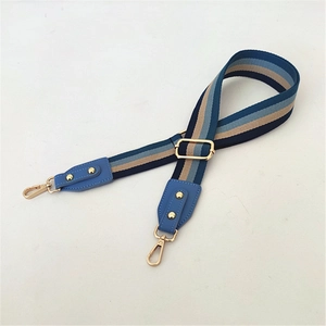 Adjustable canvas replacement shoulder strap with blue and beige stripes and gold hooks