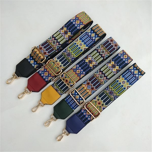 Close-up of five colorful embroidered bag straps with geometric patterns and gold hooks