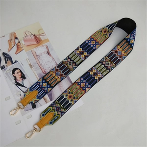 Close-up of wide ethnic style woven bag strap with colorful geometric diamond patterns